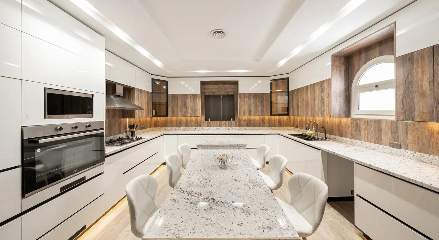 Spacious kitchen with a central granite table in El Rehab